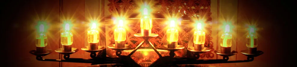 A row of lit Chanukah candles: the shul’s Chanukah 2012 banner